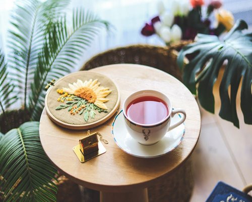 Cup of herbal tea resting on a table near a comfortable armchair
